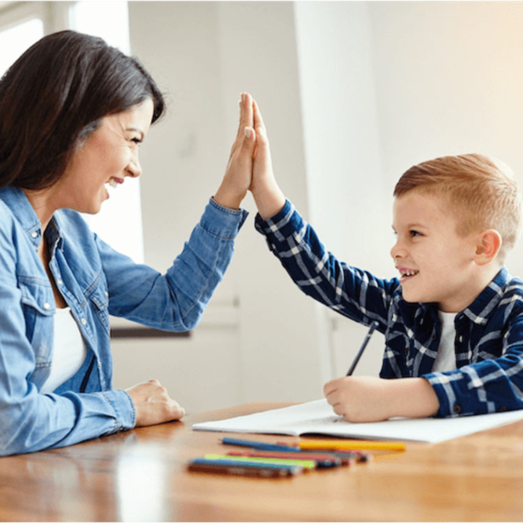 Tutoring session between elementary student and teacher in a classroom in school